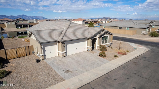 ranch-style home with a garage and a mountain view