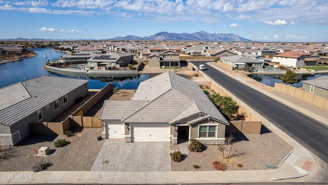 drone / aerial view featuring a water and mountain view