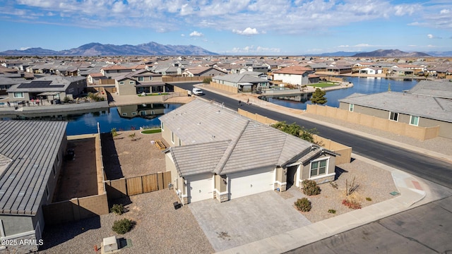 aerial view featuring a water and mountain view