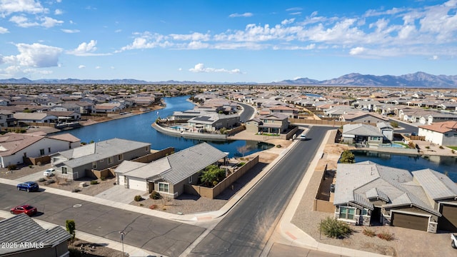 drone / aerial view featuring a water and mountain view