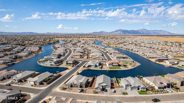 drone / aerial view with a water and mountain view