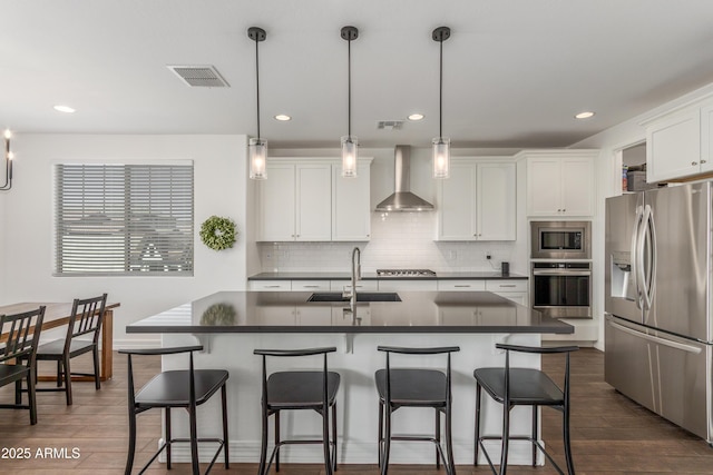 23042 E Excelsior Ave, Queen Creek, AZ 85142 - kitchen with stainless steel appliances, wall chimney exhaust hood, dark countertops, backsplash, and recessed lighting