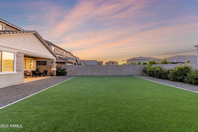 23042 E Excelsior Ave, Queen Creek, AZ 85142 - yard at dusk with a fenced backyard and a patio area