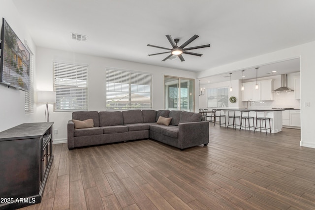 23042 E Excelsior Ave, Queen Creek, AZ 85142 - living room featuring a ceiling fan and dark wood-style flooring