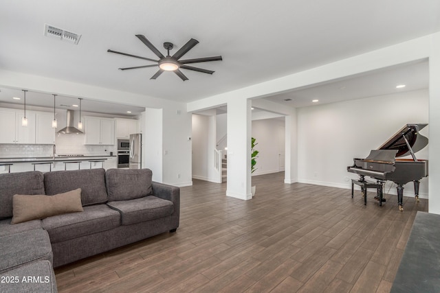 23042 E Excelsior Ave, Queen Creek, AZ 85142 - living area with ceiling fan, dark wood-style flooring, stairs, and recessed lighting