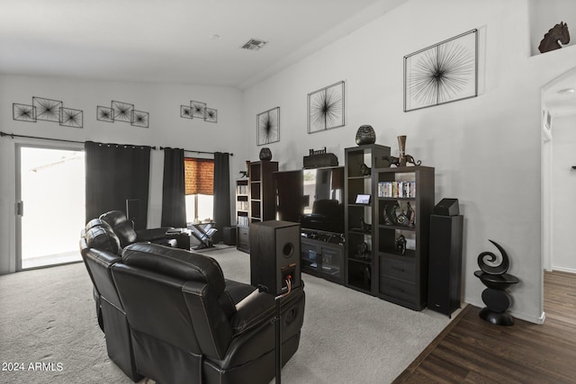 living area with visible vents, baseboards, and wood finished floors