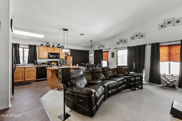 living room with vaulted ceiling, wood-type flooring, and sink