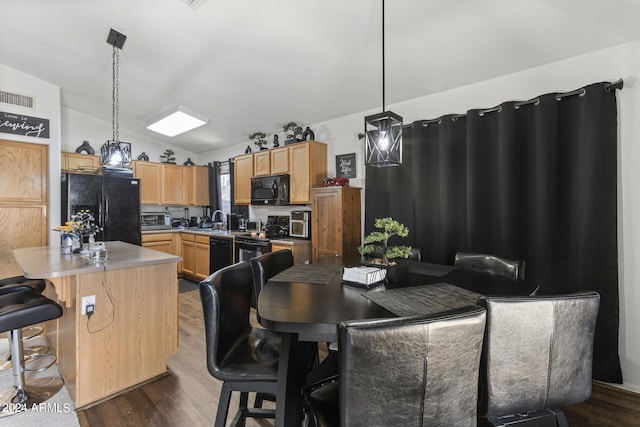 dining area with dark wood finished floors, lofted ceiling, a toaster, and visible vents