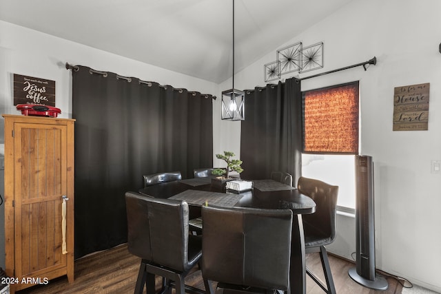 dining room featuring vaulted ceiling and dark hardwood / wood-style floors