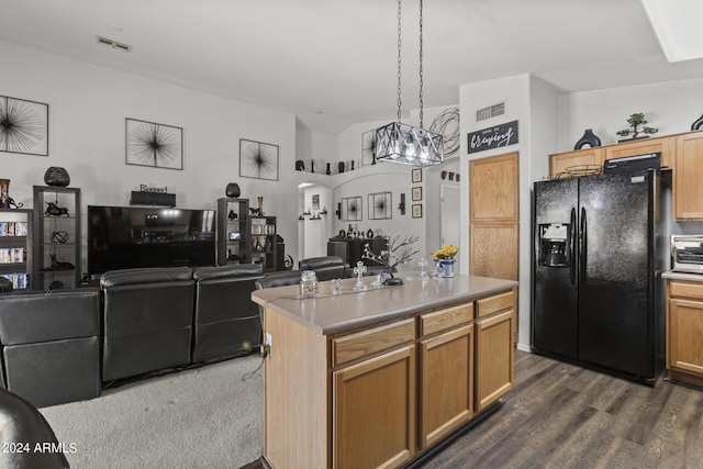 kitchen featuring arched walkways, visible vents, open floor plan, and black refrigerator with ice dispenser