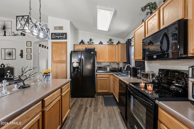 kitchen featuring black appliances, vaulted ceiling, sink, and dark hardwood / wood-style floors