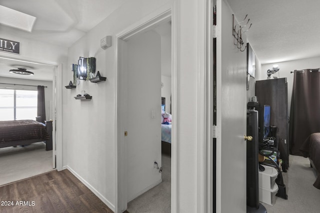 hallway with baseboards and wood finished floors