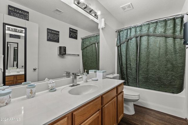 full bathroom with vanity, toilet, hardwood / wood-style floors, and shower / bath combo with shower curtain