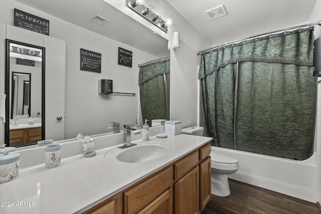 bathroom with vanity, shower / bath combination with curtain, wood finished floors, and visible vents