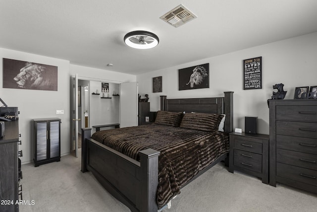 bedroom with light colored carpet, visible vents, and baseboards