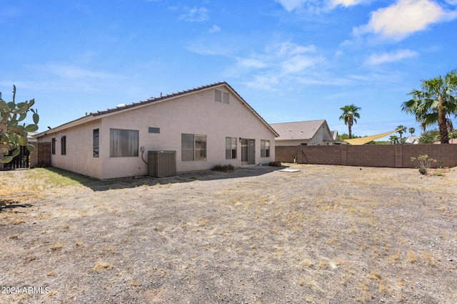 rear view of property with central AC unit