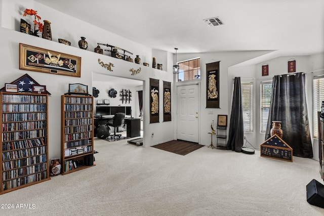 carpeted home office featuring lofted ceiling