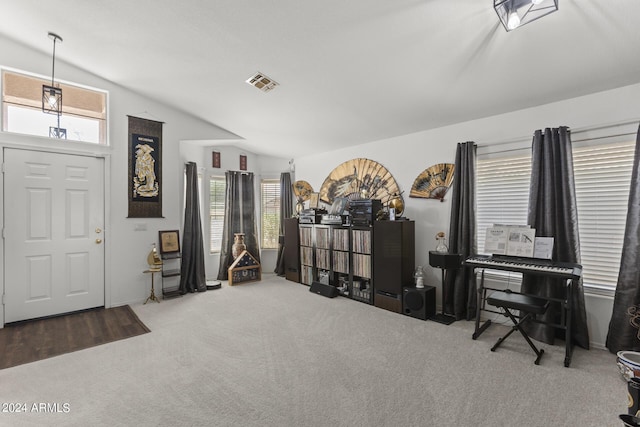 interior space featuring visible vents, carpet flooring, and vaulted ceiling