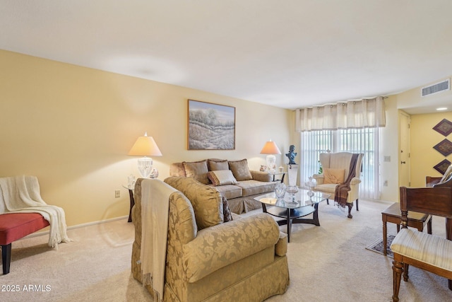 17024 N Pinion Ln, Sun City, AZ 85373 - living area featuring baseboards, visible vents, and light carpet