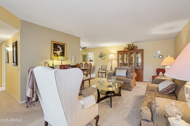 17024 N Pinion Ln, Sun City, AZ 85373 - living room with light carpet, baseboards, and ceiling fan