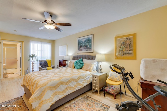 17024 N Pinion Ln, Sun City, AZ 85373 - bedroom featuring wood finished floors, ensuite bath, and a ceiling fan
