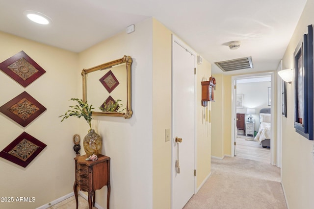 17024 N Pinion Ln, Sun City, AZ 85373 - hallway with light colored carpet, visible vents, and baseboards