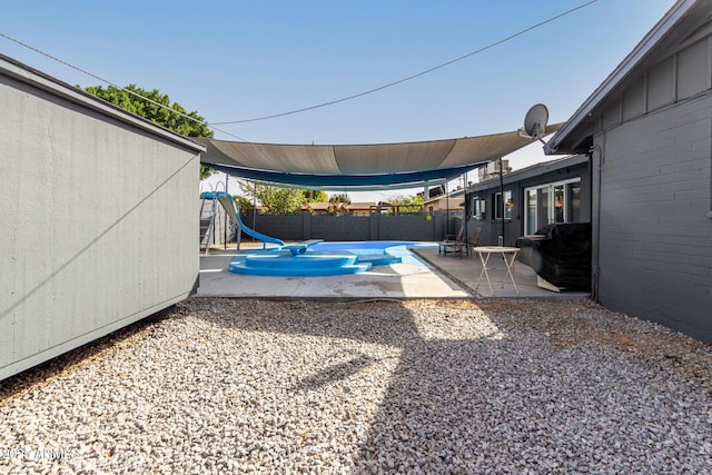 view of patio featuring a fenced in pool, a fenced backyard, and a playground