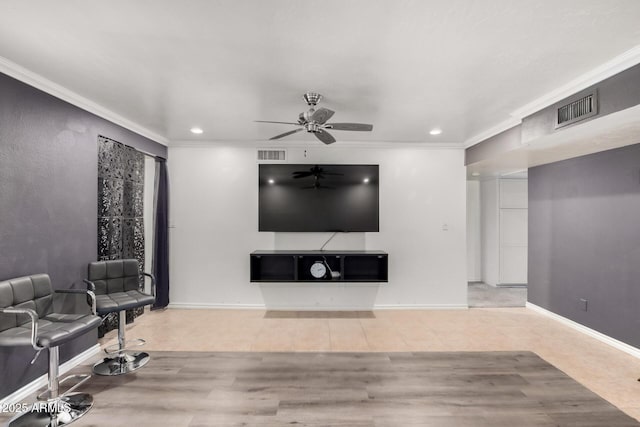 living room with tile patterned flooring, visible vents, and crown molding