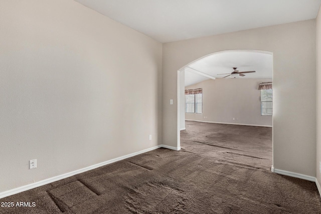 5901 E Leonora St, Mesa, AZ 85215 - empty room with baseboards, arched walkways, a ceiling fan, carpet floors, and vaulted ceiling