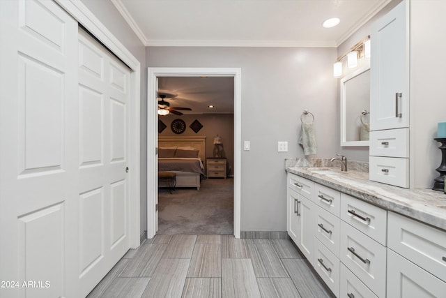 bathroom with vanity, crown molding, and ceiling fan