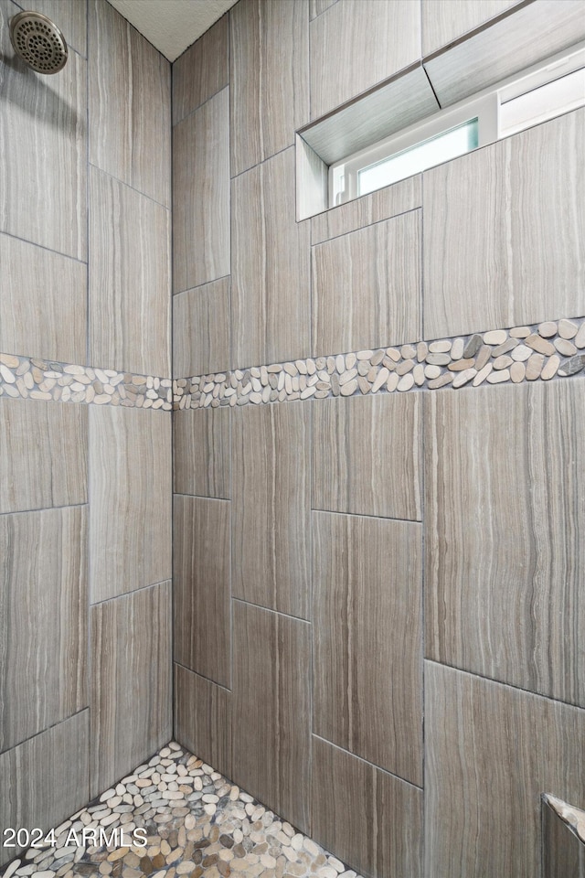 bathroom with tiled shower