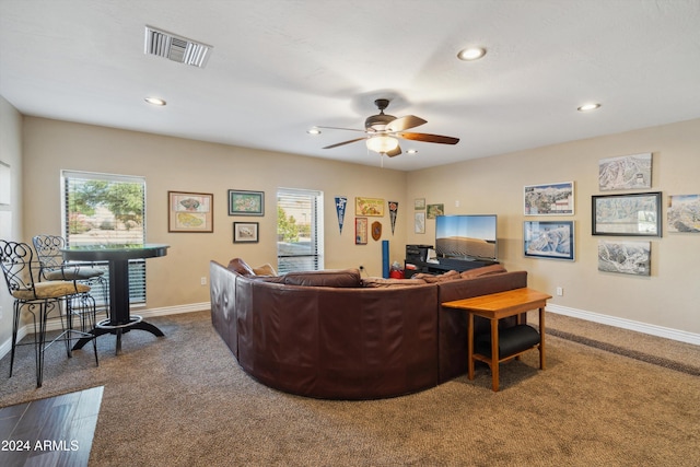 carpeted living room featuring ceiling fan