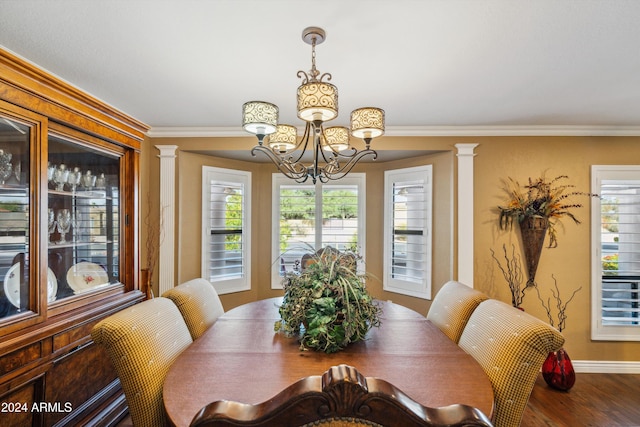 dining room featuring a wealth of natural light, crown molding, ornate columns, and wood-type flooring