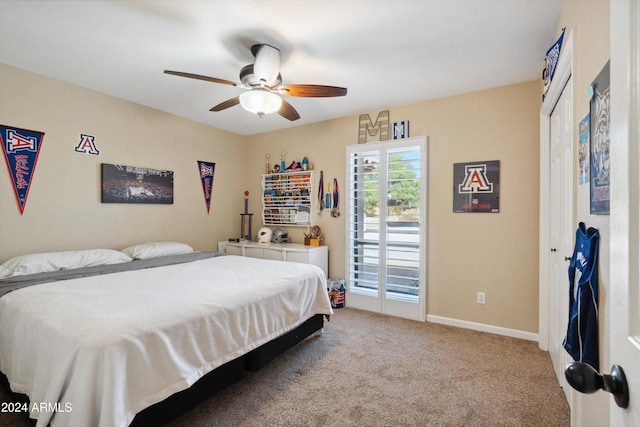 bedroom with a closet, ceiling fan, and light colored carpet