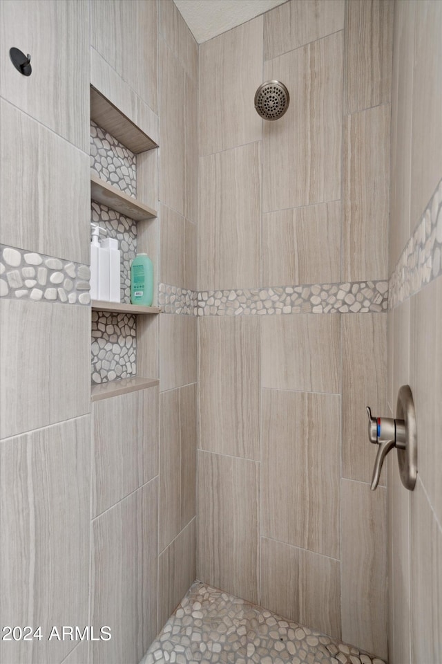 bathroom with a tile shower