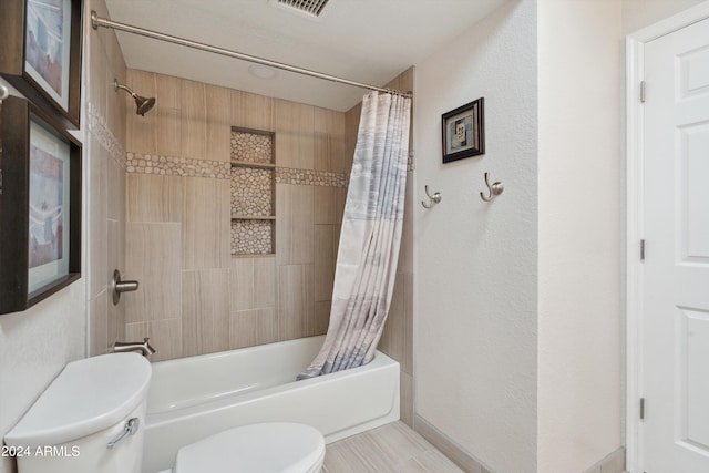 bathroom featuring toilet and shower / tub combo with curtain