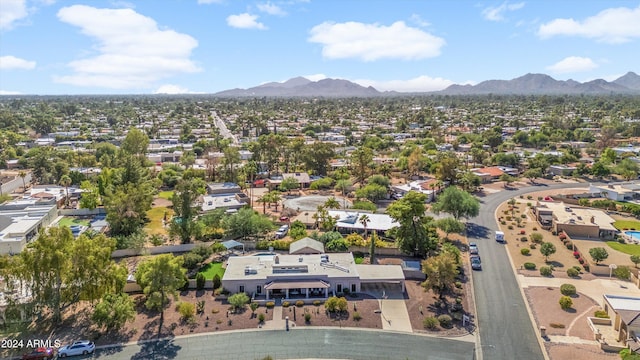 birds eye view of property with a mountain view