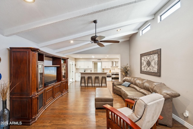 living room featuring lofted ceiling with beams, hardwood / wood-style flooring, and ceiling fan