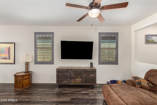 living room featuring ceiling fan and dark hardwood / wood-style floors