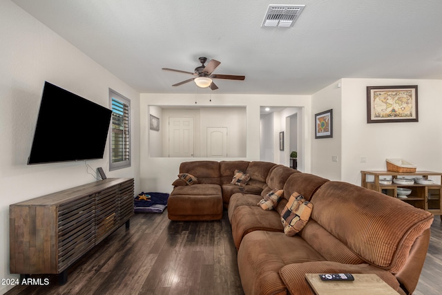 living room with ceiling fan and dark wood-type flooring