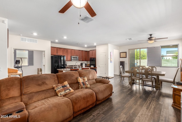 living room with ceiling fan, dark hardwood / wood-style flooring, and sink