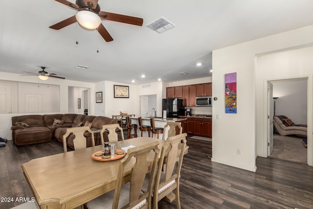 dining room featuring dark hardwood / wood-style floors and ceiling fan