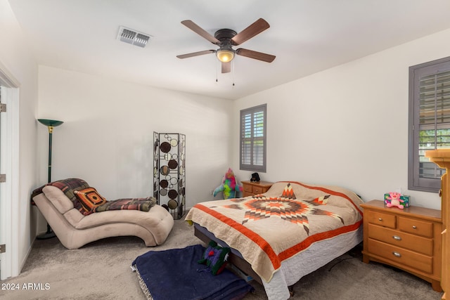 bedroom featuring carpet flooring, multiple windows, and ceiling fan