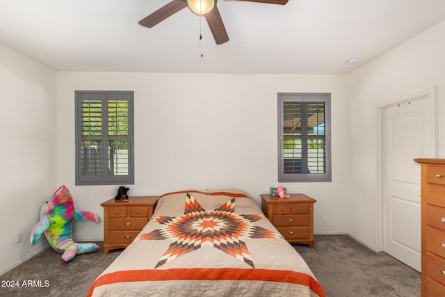 carpeted bedroom featuring ceiling fan and multiple windows