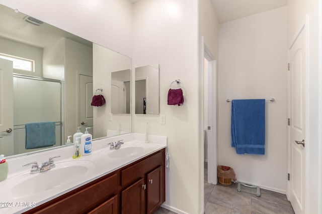 bathroom featuring tile patterned floors, vanity, and an enclosed shower