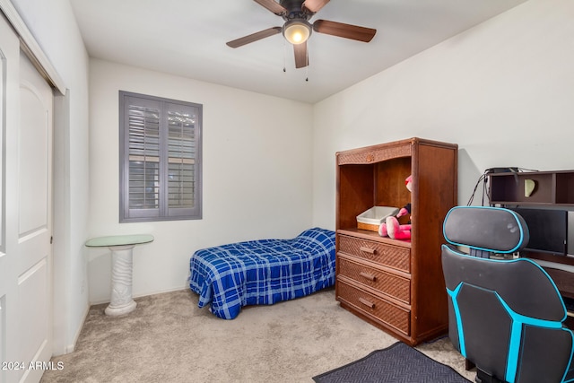 bedroom with a closet, light colored carpet, and ceiling fan