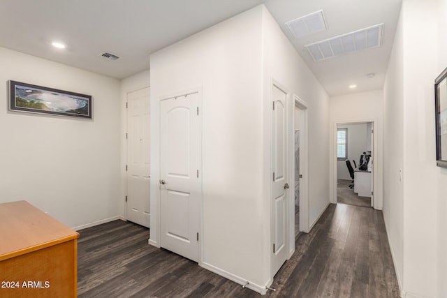 corridor with dark hardwood / wood-style floors