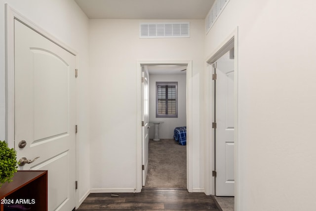 hall with dark wood-type flooring