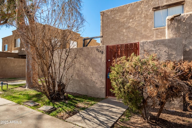 4240 N 67th Ln, Phoenix, AZ 85033 - view of property exterior featuring fence, a gate, and stucco siding