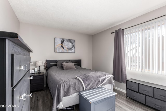 4240 N 67th Ln, Phoenix, AZ 85033 - bedroom with baseboards, wood finished floors, and a textured ceiling